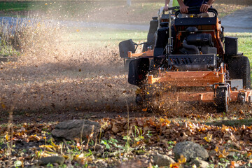 leaf mulching machine n a fall yard as it grinds up leaves