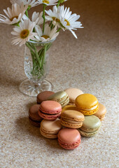 Plate of French macarons with daisies