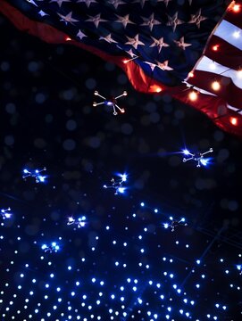 Lit up drones during an air show with red and blue lights for the forth of July.