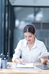 The Asian female business professional displayed a cheerful expression in her office.