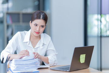 The Asian female business professional displayed a cheerful expression in her office.