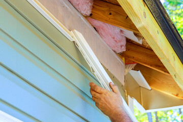 During construction exterior of house, damaged plastic siding is replaced