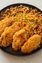 Korean instant noodles with fried chicken or Fried chicken ramyeon