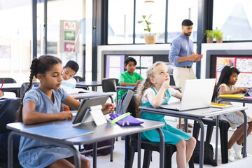 Diverse children engage in studies in a bright classroom, embracing education