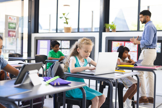 In school, diverse group of young students focusing on their studies in the classroom