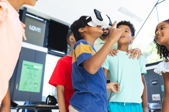 In school, diverse group of young students are exploring virtual reality