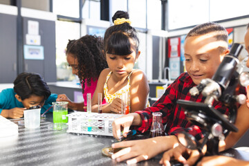 Children engage in a science experiment at a classroom table in school