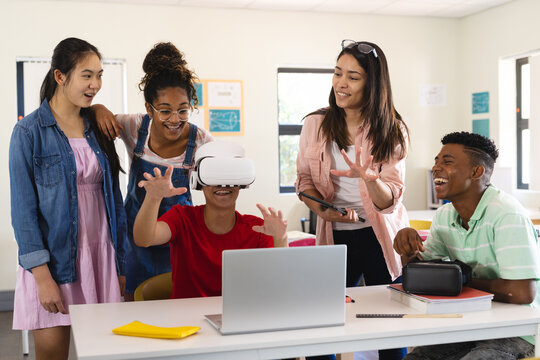 Diverse students explore virtual reality in a classroom in high school