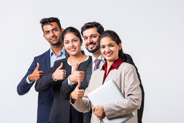 Indian asian young business professionals executive standing in group and looking at camera
