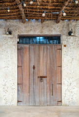 old brown wooden door retro and vintage lamp style or ancient house double wood doors with rusty hinge lock to close on white crack cement wall background for home texture backdrop at al seef dubai