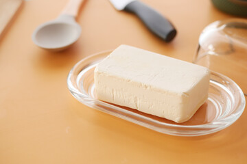 fresh butter in a glass jar on table 