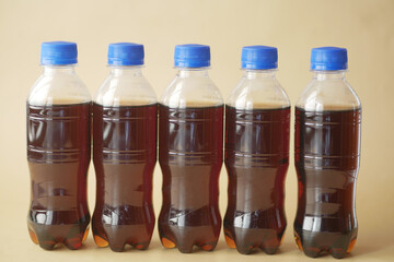 plastic bottles of soft drink on table 