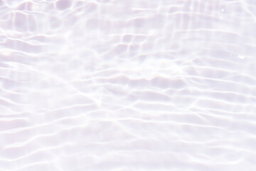 White water with ripples on the surface. Defocus blurred transparent white colored clear calm water surface texture with splashes and bubbles. Water waves with shining pattern texture background.