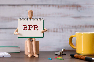 There is notebook with the word BPR. It is an abbreviation for Business Process Re-engineering as...