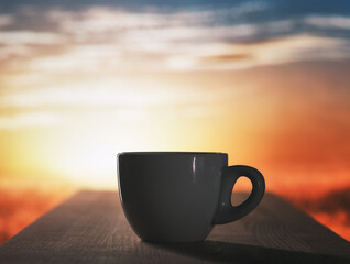 Cup of Coffee on Wooden Table at Sunrise