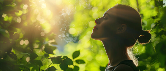 Young woman enjoying the beauty of nature and fresh air in the forest