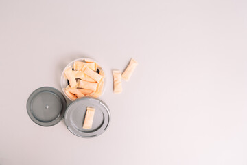 Plastic jar with fruit flavored snus sachets.