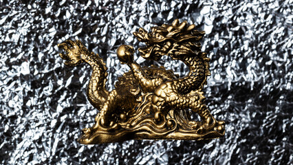 Fototapeta premium Golden dragon on a silver background. Chinese culture