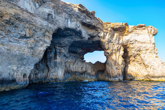 Rock formation in calm sea water. Unique rock structure in ocean - Powered by Adobe