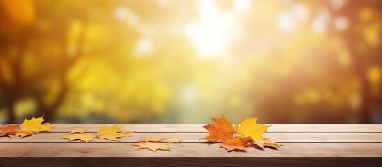 Autumn-themed background complements a wooden table with a clear surface for a vibrant copy space image.
