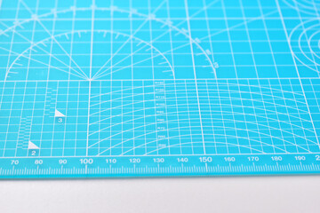 blue cutting mat board on white background with line and scale measure guide pattern for object art...