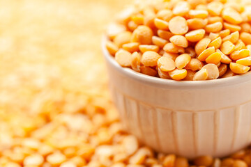 Uncooked, yellow peas in bowl. Split peas grains