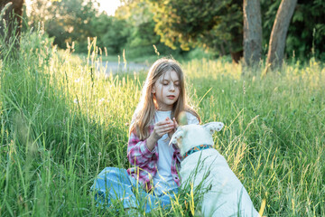 A child with a dog in nature