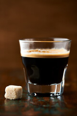 Coffee in glass cup on dark background. Close up. Copy space