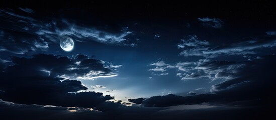 An enchanting nocturnal scene with the moon obscured by dense clouds, casting a gentle radiance, generating a tranquil and enigmatic mood in the sky with copy space image.