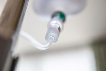 Close up medical intravenous IV drip in hospital background