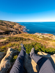 Sitting on a rock looking at the sea on Mount Jaizkibel next to San Sebastian, Gipuzkoa, Basque...