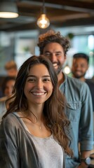 Fototapeta premium portrait of a smiling young woman with long brown hair in a grey cardigan