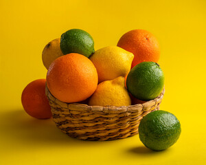 orange, lemon, lime, citrus aroma concept on yellow background, focus stacking studio photo