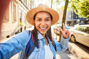 Cheerful woman taking selfie during European city break