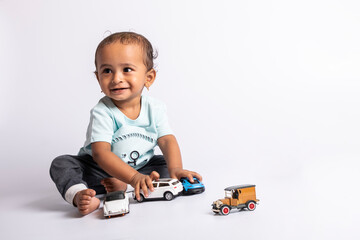 child playing with car. little boy playing miniature car. Joyful baby playing with toys. baby boy...