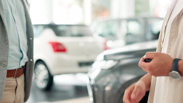 Handshake, man and car dealership with keys, salesman and customer for successful purchase or test drive agreement. Motor vehicle, showroom and rental with businessman, thank you and automobile sale