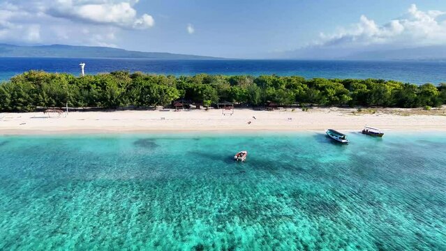 aerial view of beach with clear blue sea water, calm waves and white sand on uninhabited island. Tabuhan Island, Banyuwangi, Indonesia