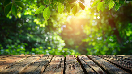 Empty wooden table with blurred spring background, green leaves and sunlight in the forest.