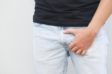 man covers groin, health problems disease for premature ejaculation, fertility, erection. The concept of protection of sexually transmitted infections. prostate problem testicular cancer.