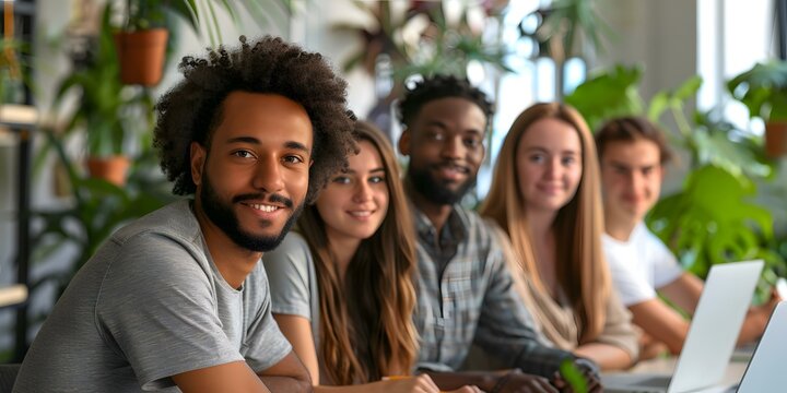 portrait of a group of young professionals smiling and looking at the camera