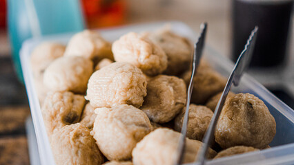 A box containing round pempek for sale
