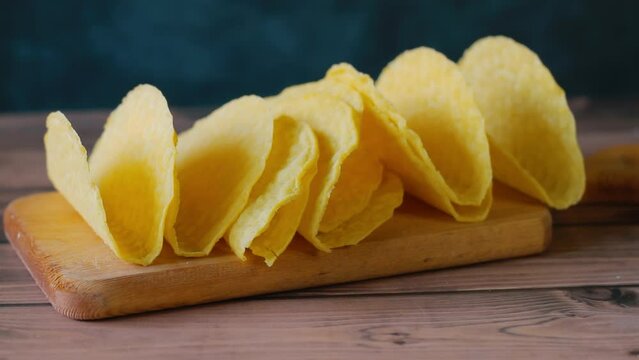 Empty taco shells on a wooden work surface