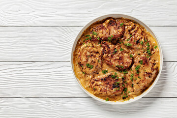 creamy smothered pork chops cooked in onion gravy
