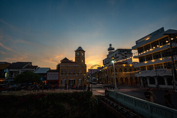 Tourists like to take photos at the clock tower, an old building in Phuket city. beautiful sky in twilight.popular landmark in Phuket. a beautiful old building in the heart of Phuket Town.
