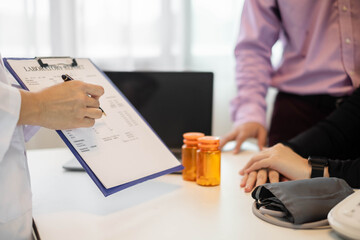 Female doctors who treat patients make an appointment to listen to the results after a physical examination and explain medical information and diagnose the disease. Medical concepts and good health