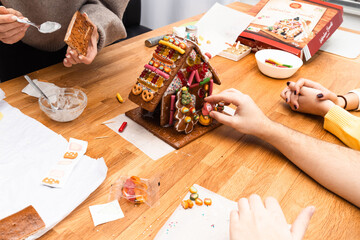 A group of young people design gingerbread cookies house