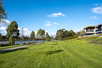 Background texture of a waterfront park with an open green lawn and some modern houses nearby offers a beautiful living environment along the Maribyrnong River in Melbourne, VIC, Australia.
