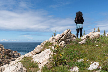 Hiker looking at the sea on the Asturian Coast