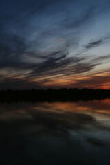 beautiful sunset on the river bank. dramatic sky of different colors. sunset