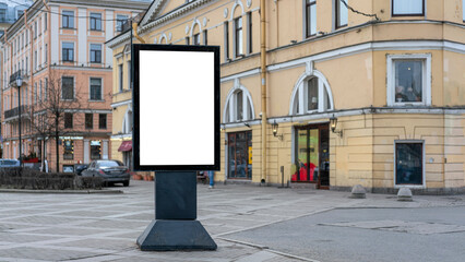 Blank white billboard in urban setting with historic buildings in background. Ready for advertising...